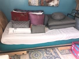 Twin size bed resting on a pallet frame. 