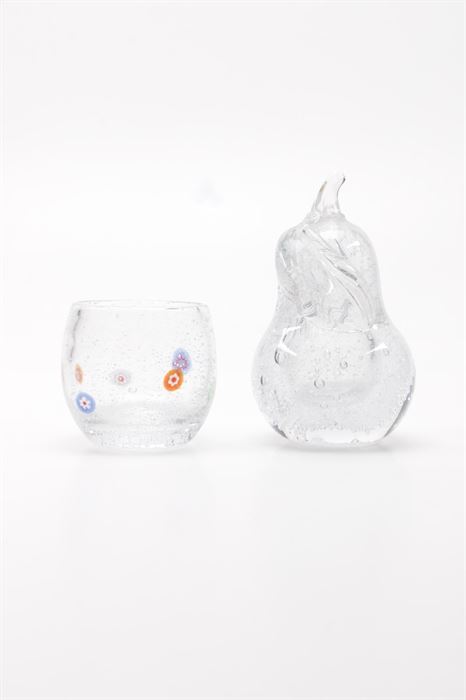 Art Glass Pear Figurine and Vase: An art glass pear figurine and vase. The pear shaped figurine features a leaf to top and is made of clear glass. The small vase has pink, blue, and violet flower decorations on clear glass.