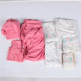 Set of Pink and White Bed Sheets: Two sets of pink and white bed sheets. The set includes a set of white sheet and a set of pink sheets. The white sheets have a pink rose border.