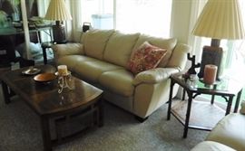 Leather couch, Asian style tables and brass lamps