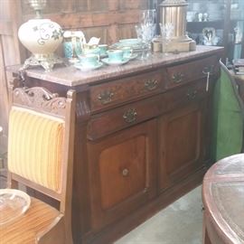Vintage Side Board with Marbe Top
Coffee Cup and Saucer
A vintage padded chair and a leather topped side table