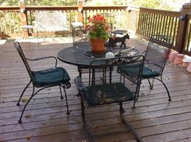 Wrought iron patio table and four chairs