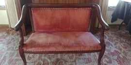 Antique setee with nailhead trim