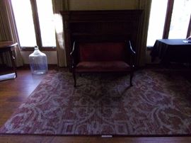 Antique setee with nailhead trim, large area rug
