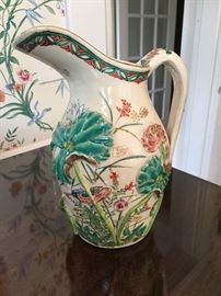 Exquisitely detailed relief molded earthen ware pitcher.