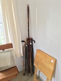 Antique canes and umbrellas with silver and ivory trim. 