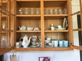Tea cups and pots and cups for coffee too.  On the third shelf not the French beet steins and the acid etched Heisy beer steins.
