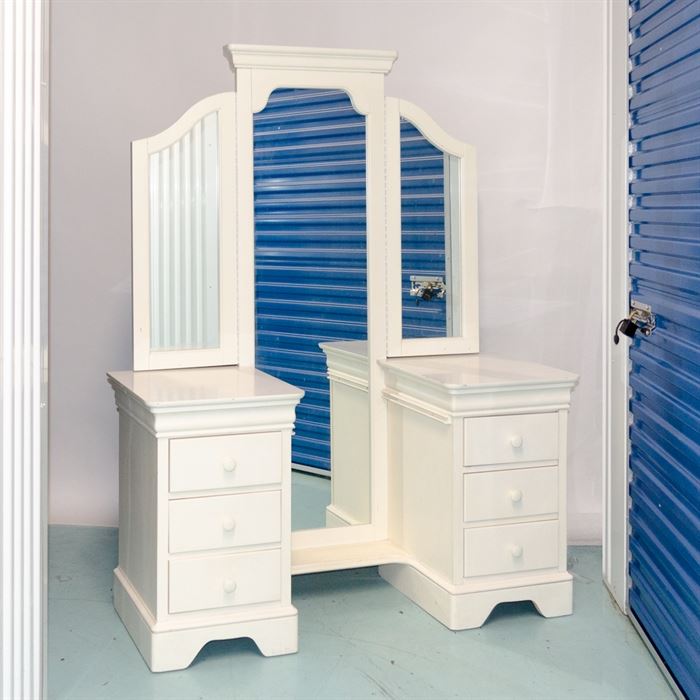 Stanley Furniture Mirror with Two Chests: A Stanley Furniture mirror with chests. The full-length mirror features a straight pediment with two hinged side mirrors. Flanking the full-length mirror are two rectangular chests of drawers, each with three stacked drawers with round knobs. The piece, which is painted white throughout, stands on bracket feet.