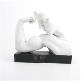 TMS Vitruvian Sculpture "Adoration": A ceramic sculpture from the TMS Vitruvian Collection of a classical style man flexing titled Adoration. This sculpture depicts one arm and the front of a head of a figure that is flexing his bicep. The sculpture rests on a black wooden plinth.