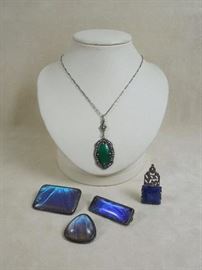 CW:  Art Deco German sterling silver, marcasite and jade pendant on original chain.  Circa 1930.  Suite of English sterling silver brooches with butterfly wings under domed glass, circa 1920s.  Lapis and silver dress clip. 