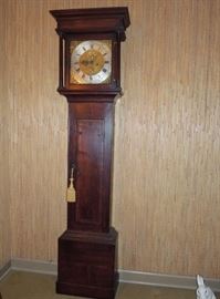 BAT:   18th century Irish country longcase clock with crossbanded oak case.   Brass dial with wide silvered chapter ring, gilded spandrels, calendar aperture and silvered seconds ring signed "J. Gelston, Newry."  John Gelston (ca.1730-1804)  81" H x 21" W x 10.5" D  