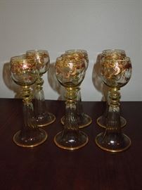 CW:  Set of six Rhine wine goblets blown of pale green tinted glass, hand cut and richly embellished with gold decor.  Bohemia, circa 1910. 