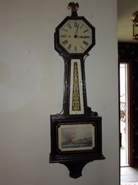 BAT:   Rare 30-day running New Haven mahogany banjo clock.  Mahogany case with octagonal head, reverse-painted throat tablet.  Circa 1920.