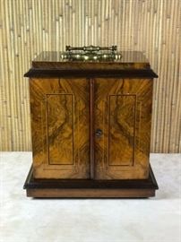 BAT:  Exceptional antique Circassian walnut and inlay jewelry box.  Heavy cast brass plate and handle, three drawers with campaign style brass hardware.  Fine color and patina.  Original throughout.  English, circa 1880.  