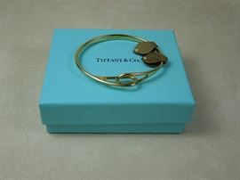 Tiffany & Co. 18K yellow gold "Interlocking Loops" bangle bracelet.  23.9 grams  Discontinued model in fine condition complete with box & drawstring pouch.  