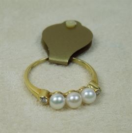 18K gold, 4mm cultured pearls flanked by bezel set full cut diamonds in a classic setting