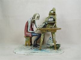 BAT:  Lo Scricciolo hand sculpted and painted Italian porcelain sculpture - The Clockmaker toiling at his bench.  1970s.