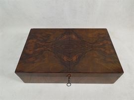 Austrian Art Deco figured walnut jewelry box of superb quality.  Matched veneers, green velvet lined & fitted  interior, functional lock.  Circa 1930s.  Exceptional color and polish.