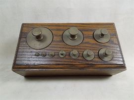 BAT:  Set of graduated brass scale weights in fitted oak block.
