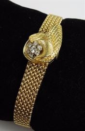 Circa 1960 Cocktail Watch of 14K gold with hidden dial; stylized flower with six full cut diamonds, integral mesh band.  Swiss 17-jewel movement by Desky Watch Co.  27.2 grams (movement/dial removed)