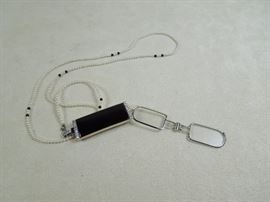 Lorgnette unfolded - 14K white gold spectacle frame.