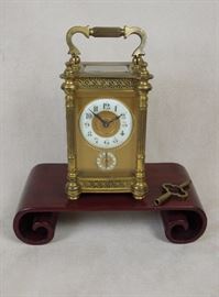 Antique French carriage clock in elaborate gilded brass case. Cream enamel dial and alarm rings with matte masks, beveled glasses.  Completely original and running order.  Circa 1910.  