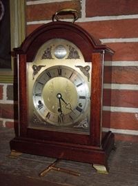 Choice Elliott, London mahogany arch-top bracket clock of George III style.  Earliest example (ca. 1960) incorporating Westminster & Whittington chimes on tuned bronze rods with auto night silence feature and high grade fully jeweled lever platform escapement.  Fine original condition / operating order.