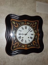 French picture frame clock with elaborately inlaid dial surround.  15-day "birdcage" movement repeating the hour two minutes after.  Circa 1880.