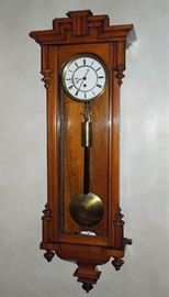 BAT:  Attractive circa 1870 walnut cased single weight Vienna regulator of small size.   Two-piece fired enamel dial with delicate cut steel hands.   Very well preserved with fine color and finish.   38" x 13" x 5.75"