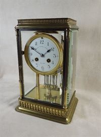 BAT:   French crystal regulator with elegantly cast brass case and exceptionally thick beveled glasses.  Fired enamel dial carrying the prestigious New York jeweler's name, blued steel spade hands, mercury vial pendulum.   Fine original condition.   Circa 1910.