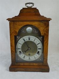 Rare Elliott, London burr walnut caddy top bracket clock of George II style, retailed by Jensen Jewelers. Early (ca. 1950) model with pendulum (versus lever platform) regulated movement chiming Westminster on tuned bronze rods.  Fine original condition with mellow color and patina.