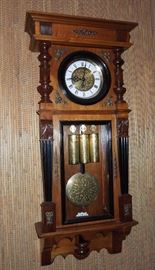 BAT:  Three-weight Vienna regulator (grande sonnerie striking /repeating) with matching etched brass dial center, weight shells & bob.  Elaborate hardwood case with ebonized trim.  Circa 1890.  Good running order. 