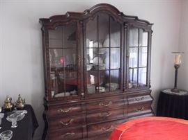 Amazing Henredon China cabinet French style with solid wood and wood veneers throughout the piece. Each section has lighting.
