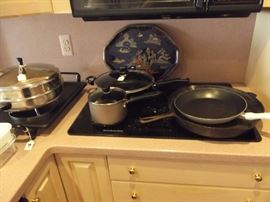 Pots and pans including a very large 14" cast iron frying pan with double spout. 