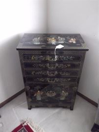 Black lacquer Asian storage dresser with hand painted scenes. 