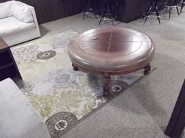 Nice unusual rug can go with many colors., very clean with no visible damage.  Also a solid large ottoman with leather seating area and solid wood base and legs.