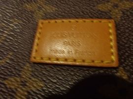 The bag is real, the registration number is inside on a leather tab.