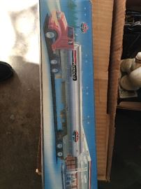 Several Amoco toy trucks still in the box