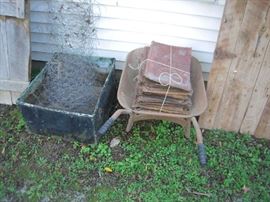 tin panels ,barn doors, old wheelbarrow , metal planter