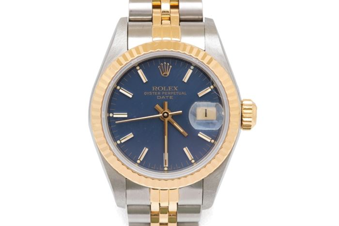 14K Gold and Stainless Rolex Oyster Perpetual Date Wristwatch: A 14K gold and stainless steel Rolex Oyster Perpetual Date Swiss Made wristwatch. This watch features a blue index dial, a sunken and magnified date window at the three o’clock position, and stainless steel case with a 14K gold fluted bezel and a stainless steel back. It attaches to a stainless steel Rolex two-tone jubilee bracelet.
