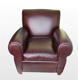 Pottery Barn Leather Club Chair: A Pottery Barn leather club chair. The contemporary brown leather chair features rolled arms and one loose seat cushion. The pieces were made by Mitchell Gold exclusively for Pottery Barn.