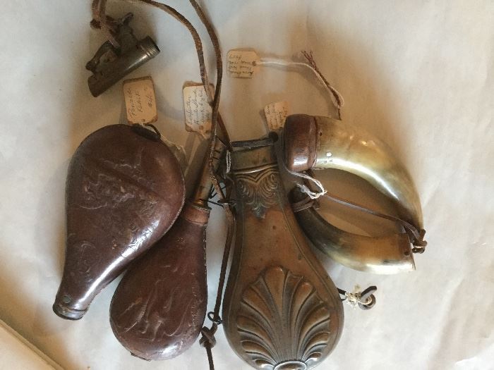 Antique powder flasks, leather, and metal