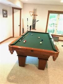 Excellent condition pool table. Comes with triangle and diamond racks, 9 sticks with wall mounting holder, a full set of pool balls, and two table brushes. Dimensions: 98" x 54". - $1,500