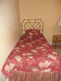 twin bed with bamboo headboard, and bamboo nightstand with lamp