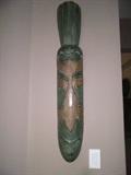 carved wall art with green/tan tones