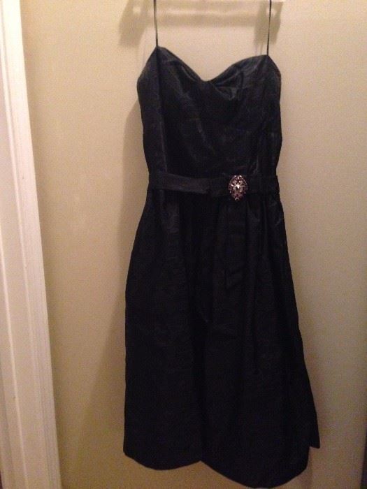 A.B.S. Designer, sweetheart shaped black, A line dress with beautiful amethyst broach. 