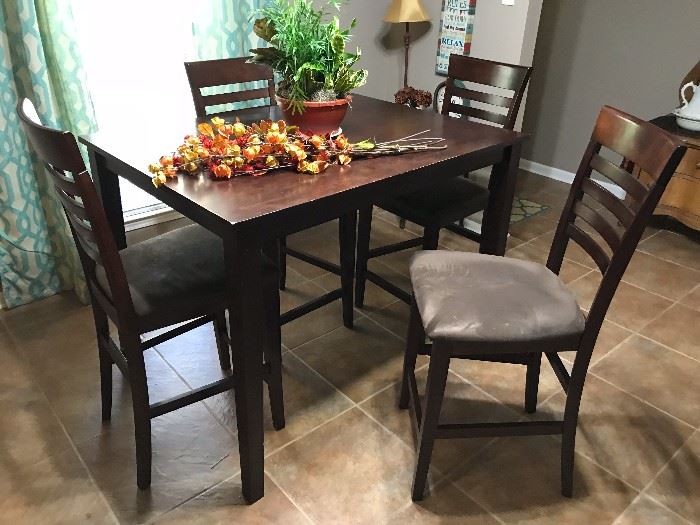 Counter height solid wood dining room table and 4 chairs.