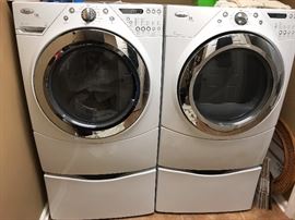 Set of Whirlpool Duet Steam washer and dryer with matching pedestals.