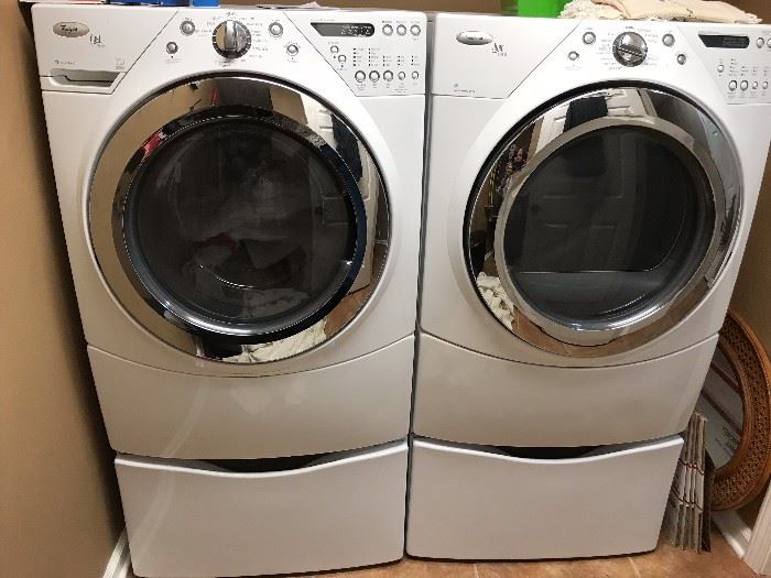 Set of Whirlpool Duet Steam washer and dryer with matching pedestals. 
