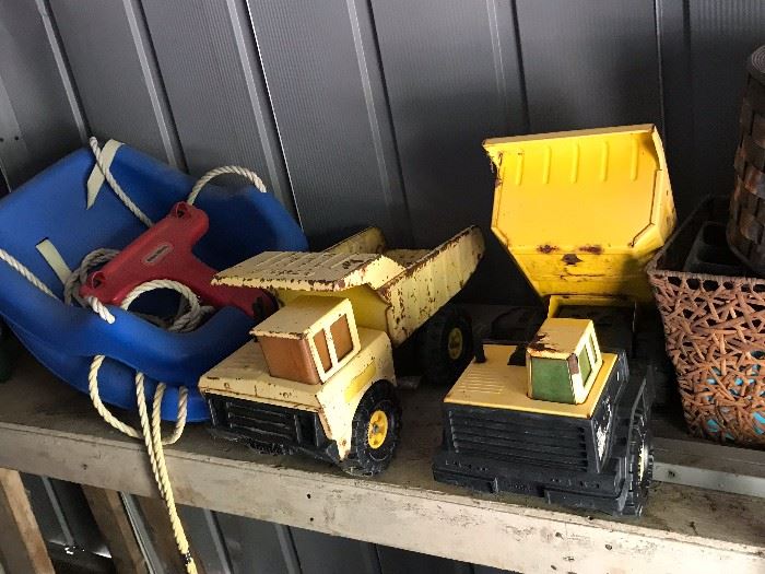 Vintage and well loved Tonka trucks. Set of 2 outdoor child swings.